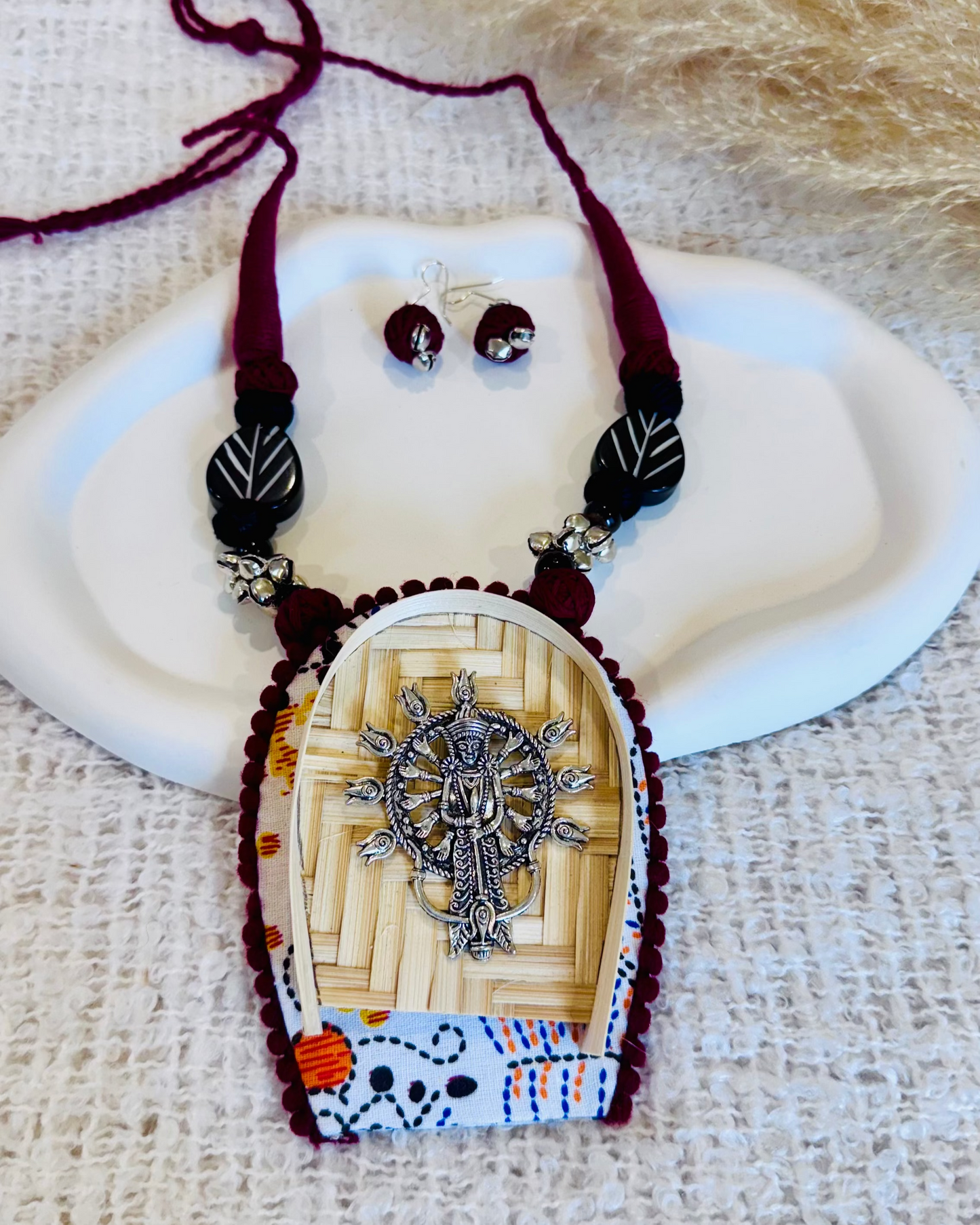 Jewelry set with a pendant and earrings on a textured surface