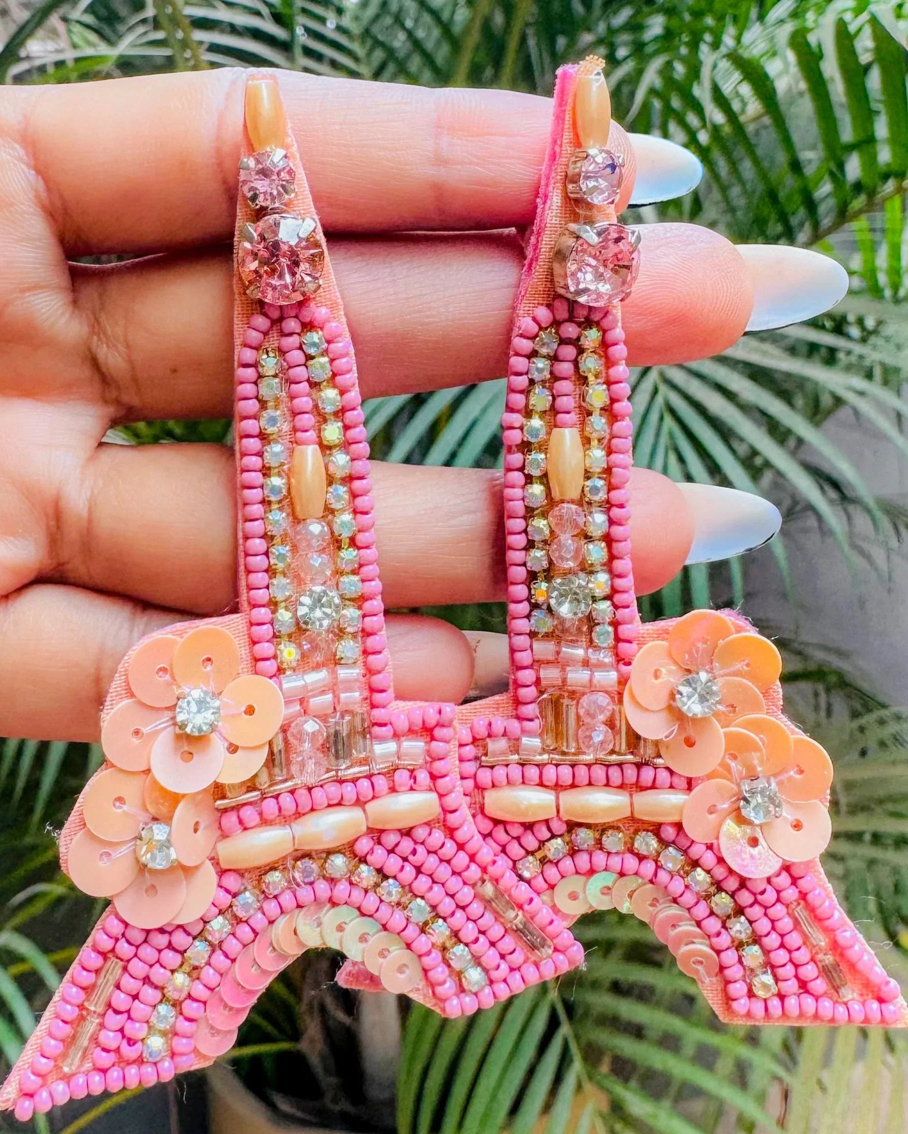 Pink and peach beaded earrings shaped like the Eiffel Tower