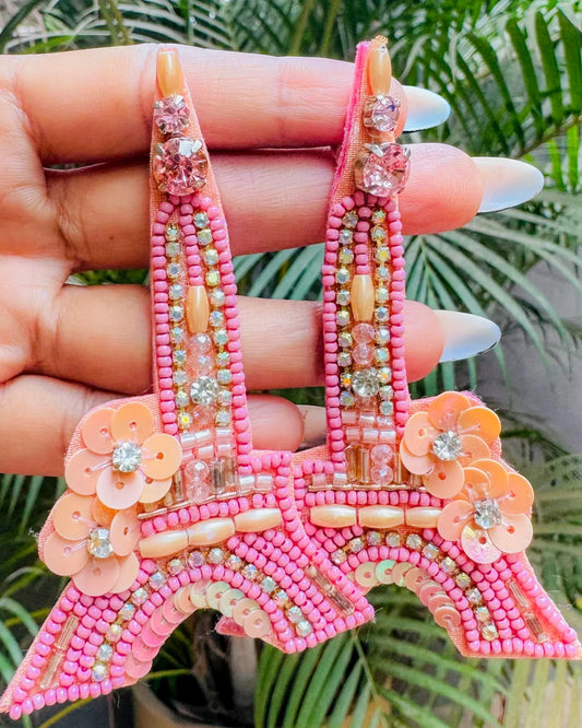 Pink and peach beaded earrings shaped like the Eiffel Tower