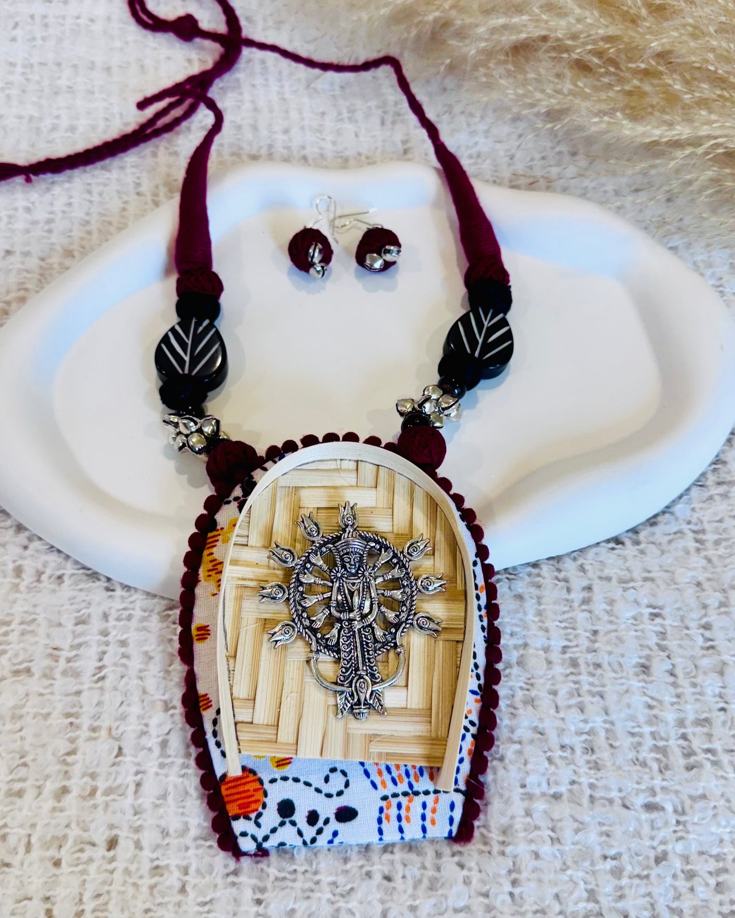 Jewelry set with a pendant and earrings on a textured surface